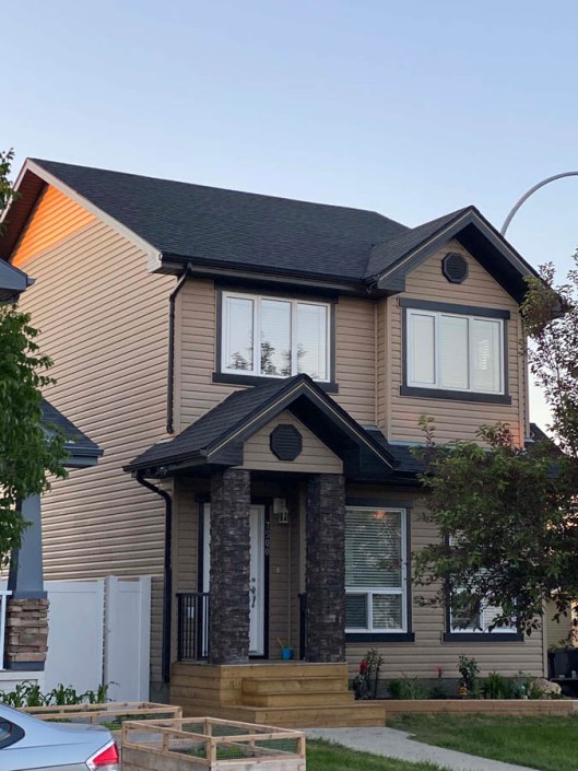 Roofing project in Regina showing a professional roofer installing asphalt shingles on a residential home.<br />